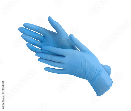 Medical nitrile gloves.Two blue surgical gloves isolated on white background with hands. Rubber glove manufacturing, human hand is wearing a latex glove. Doctor or nurse putting on protective gloves