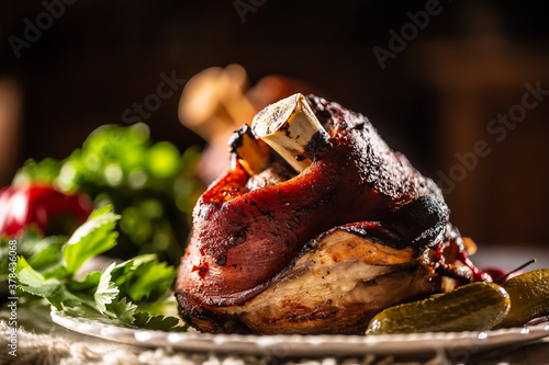 Smoked pork ham hock, pork knee served with pickled cucumbers and herbs