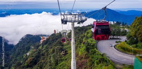 cable car at genting highlands, malaysia in a foggy weather with green grass visible from inside cable car