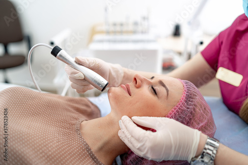 Treatment at cosmetic beauty spa clinic. Hydra vacuum cleaner. Exfoliation, rejuvenation and hydratation. Cosmetology.