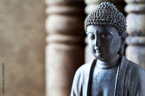 Meditating Buddha Statue on bright background. Close up. 