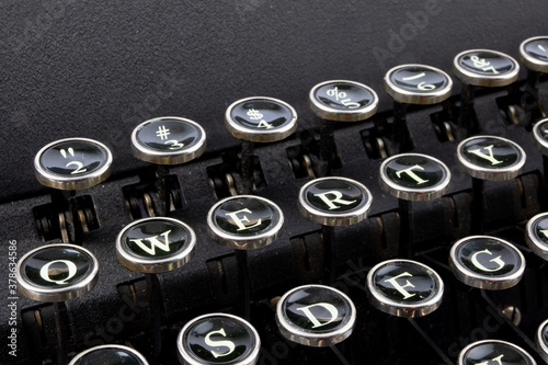 closeup of the QWERTY keys of a grungy old 1940's portable reporter's manual typewriter