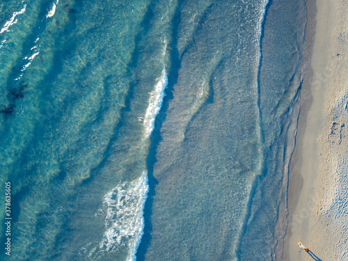 Top view of sandy beach with turquoise sea water and colorful blue umbrellas, aerial drone shot, Aerial shot Le Dunne - Porto Pino - Sardegna -Porto Pino coast, Sardinia, Italy. #2