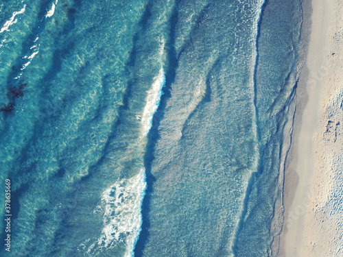 Top view of sandy beach with turquoise sea water and colorful blue umbrellas, aerial drone shot, Aerial shot Le Dunne - Porto Pino - Sardegna -Porto Pino coast, Sardinia, Italy. #1
