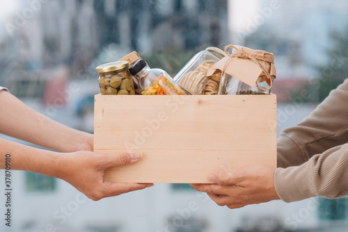 Volunteers with donation box with foodstuffs