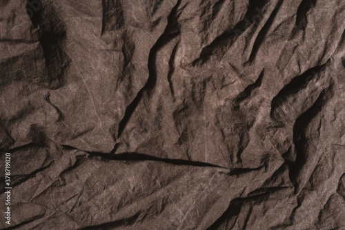 Brown crumpled natural linen cloth texture as background.