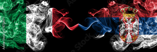 Italy vs Serbia, Serbian smoky mystic flags placed side by side. Thick colored silky abstract smoke flags of Italian and Serbia, Serbian