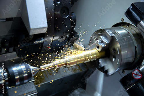 Metal machine tools industry. CNC turning machine high-speed cutting is operation.flying sparks of metalworking