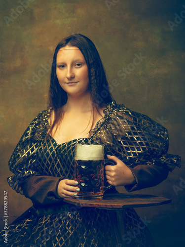 Beer time. Young woman as Mona Lisa, La Gioconda isolated on dark green background. Retro style, comparison of eras concept. Beautiful female model like classic historical character, old-fashioned.