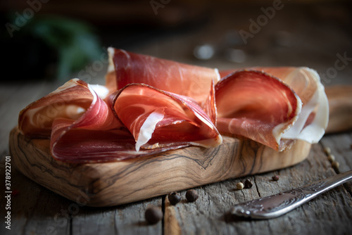 Italian prosciutto or jamon with rosemary, raw ham