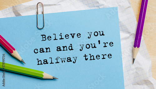 Believe you can and you're halfway there text written on a paper with pencils in office