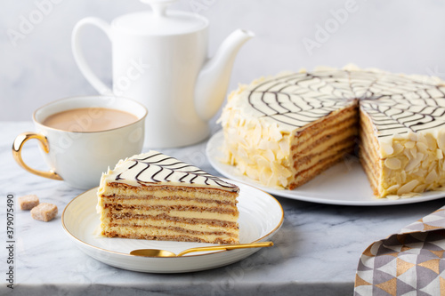 Traditional Hungarian Esterhazy cake, torte with cup of coffee. Marble background. Close up.
