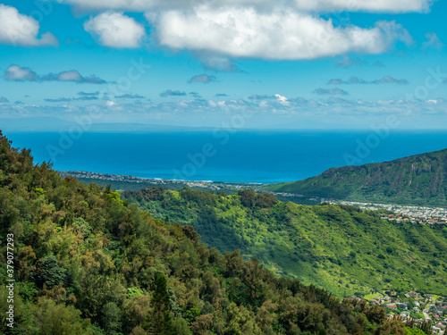 The view overlooking the town. Blue sky over green mountains. Amazing view of the ocean. Kuliouou Ridge Trail, Hawaii, Oahu