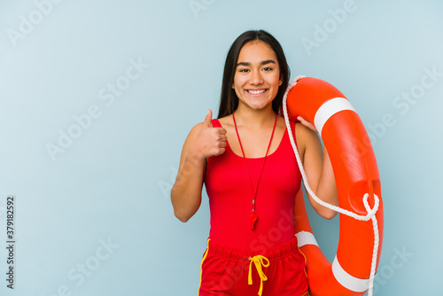 Young asian lifeguard woman isolated smiling and raising thumb up