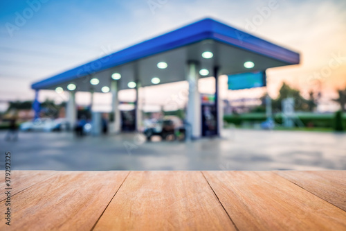 Wood table in gas station at sunset. Pump gasoline gauge oil in the evening. This photo can be used for automotive service industry or unleaded transportation concept