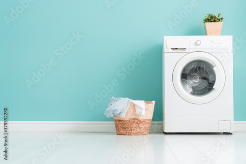 washing machine on teal wall background