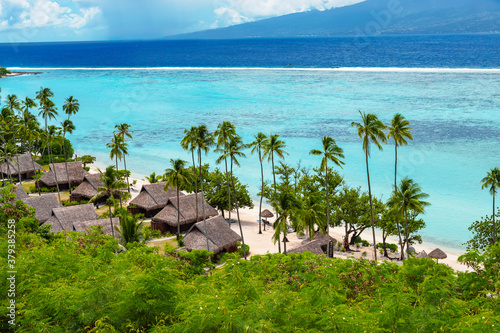 Luxury travel vacation with beach villas on Moorea Island, French Polynesia.