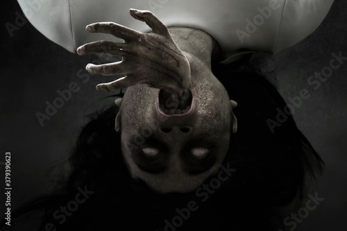 Woman possessed on dark background