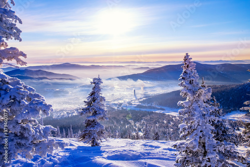 Sheregesh Kemerovo region ski resort in winter dawn sun on city, landscape on mountain and hotels, aerial top view