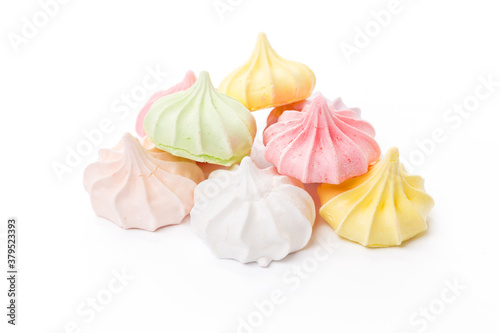 Pile of colorful meringue cookies isolated on white