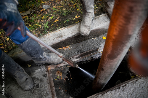 Cleaning storm drains from debris, clogged drainage systems are cleaned with a pump and water