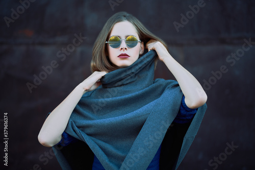 trendy model in gray poncho