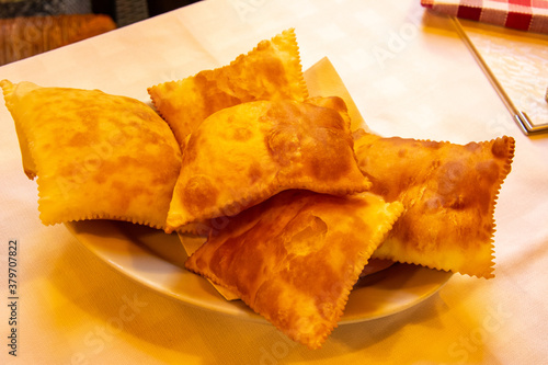 The "gnocco fritto" or "crescentina" bread in Italian cuisine from the Emilia region of Italy, prepared using flour, water and lard as primary ingredients, served for the appetizers in Parma, Italy