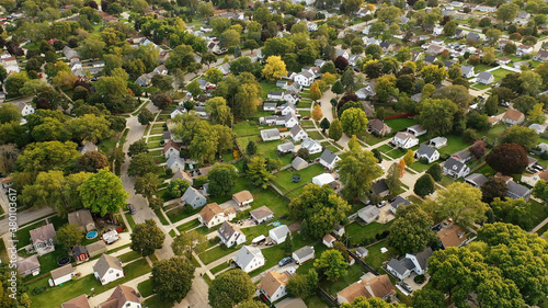 Aerial drone view of American suburban neighborhood. Establishing shot of America's suburb. Residential single family houses pattern. Autumn Fall season