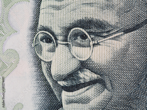 Mahatma Gandhi face on indian 100 rupee banknote extreme macro, India money closeup