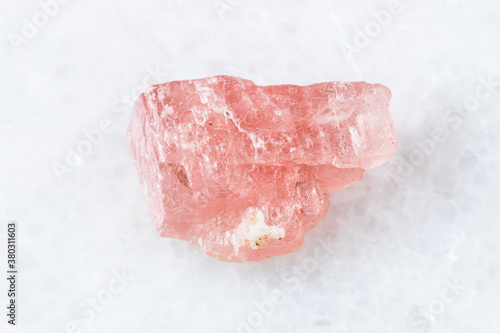 closeup of sample of natural mineral from geological collection - rough Rhodochrosite crystal on white marble background from Wutong mine, Liubao, Guangxi prov, China