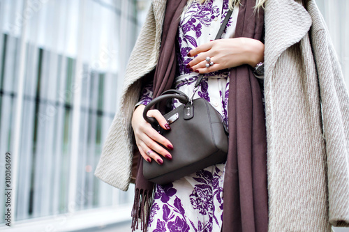 Close up fashion details, taupe trendy colors, woman wearing elegant coat, floral maxi dress, crossbody bag, trendy accessories and jewelry, spring autumn time, burgundy manicure.