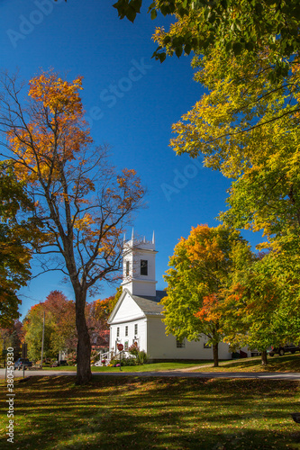 The Congregational church in Peru, Vermont. Surrounding trees are showing brilliant fall color.