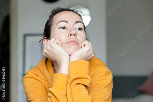 A young adult woman looking bored, being and feeling bored