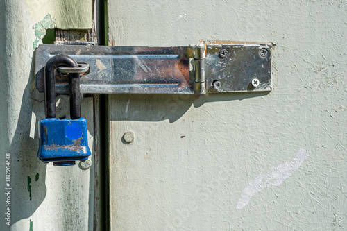 Padlock on a hasp lock on a shed door