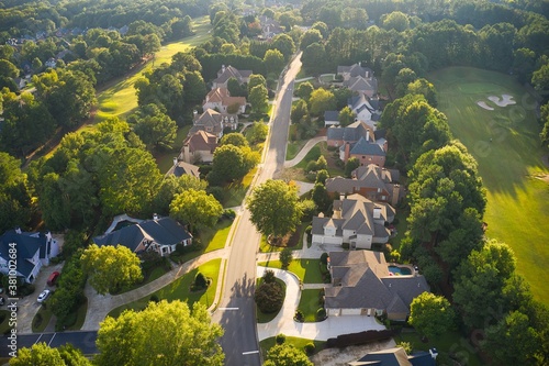 Beautiful aerial view of a sub division with golf course and a beautiful lake in suburbs of Atlanta during golden hour.