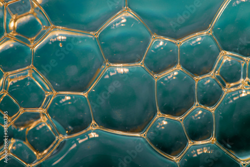 Natural texture of soap foam bubbles super macro closeup. Cool polygon geometric 3d pattern background. Sientific cell tissue molecular texture wallpaper. Hexagonal aquamarine marble network structure