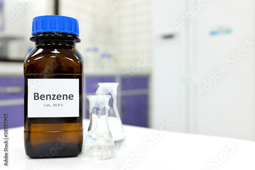 Selective focus of benzene liquid chemical compound in dark glass bottle inside a chemistry laboratory with copy space. Aromatic hydrocarbon used in petrochemical industry. 