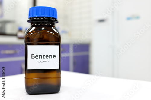 Selective focus of benzene liquid chemical compound in dark glass bottle inside a chemistry laboratory with copy space. Aromatic hydrocarbon used in petrochemical industry. 