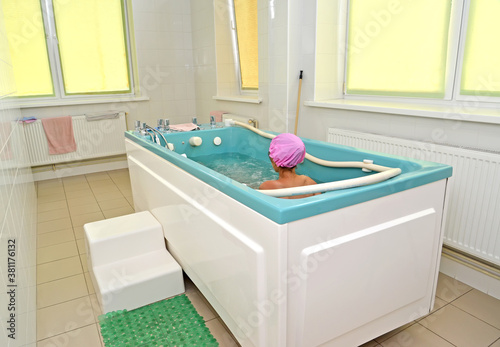 The child takes a treatment bath in the water clinic of the children's sanatorium