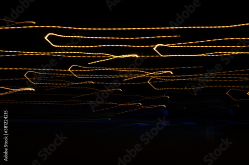 Golden threads, yellow neon signs on a black background.