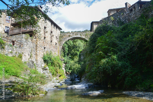 BEGET, CATALONIA, SPAIN, EUROPE, SEPTEMBER 2020. Beautiful landscape of the medieval bridge surrounded by stone houses in the picturesque town of Beget, it is an important tourist place in Catalonia.