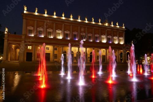The colored fountain in front of the Municipal Theatre of Reggio Emilia at night
