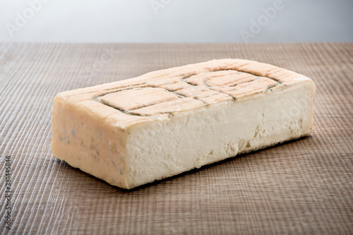 Italian aged cheese on wooden background