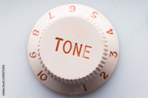 White plastic knob for tone adjustment, selective focus