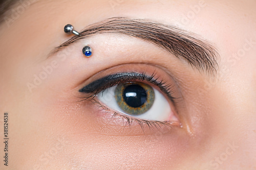 Eyebrow piercing. Eyelash tattoo. Cosmetic procedures.