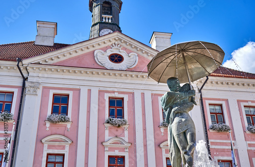 Old town hall with sculpture fountain in front of it in Tartu