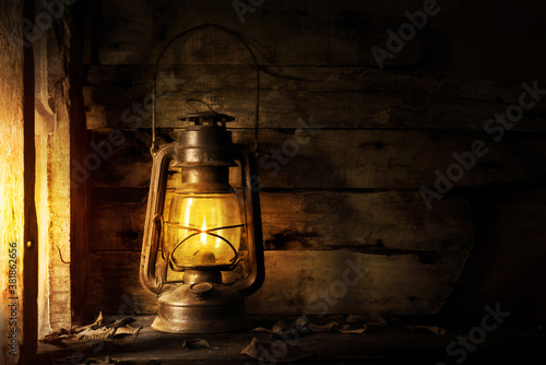 Antique lantern kerosene on an old overgrown wood