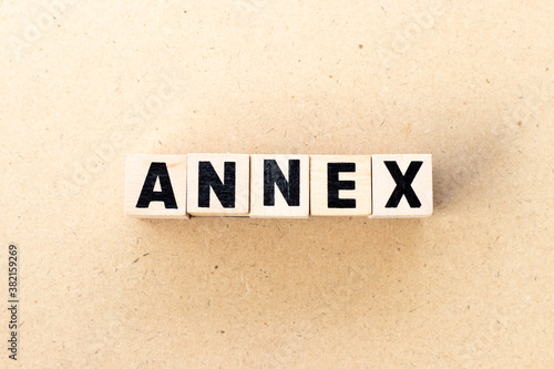 Alphabet letter block in word annex on wood background