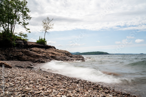 Long exposure of waves crashing over rocky shore in northern Michigan