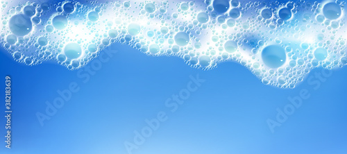 Cleaning foam with bubbles, white froth frame horizontal border, foamy texture, liquid soap or shampoo lather. Sea wave, laundry detergent spume isolated on blue background realistic 3d vector pattern